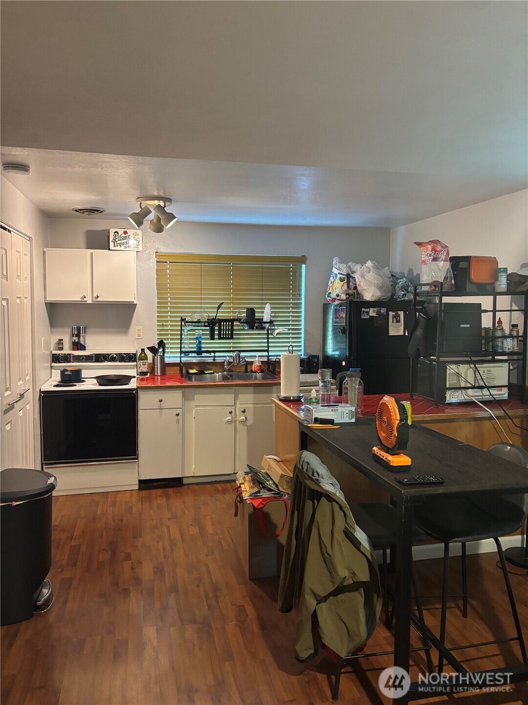 22010 Brier Road Brier, WA 98036 - Photo 22 of 34 a kitchen with stainless steel appliances kitchen island granite countertop a table chairs sink and cabinets