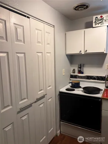 a kitchen with a sink a stove and cabinets