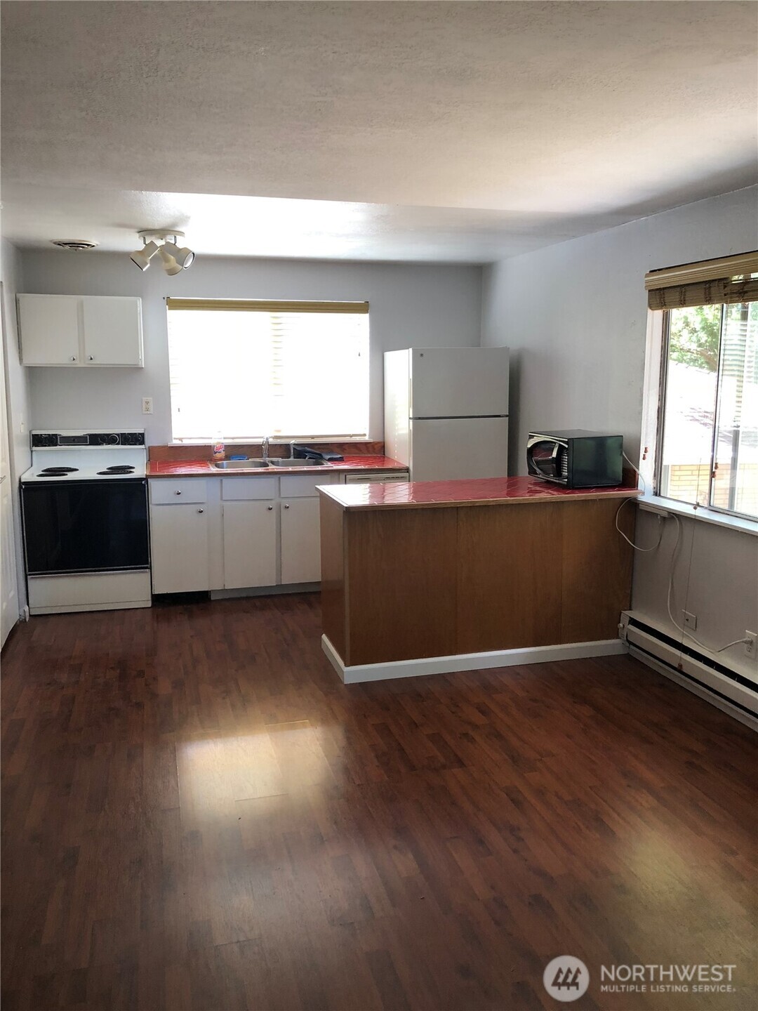 22010 Brier Road Brier, WA 98036 - Photo 24 of 34 a kitchen with granite countertop a stove and wooden floor