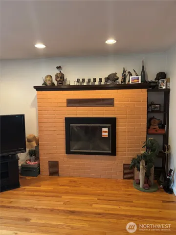 a view of a fireplace with wooden floor