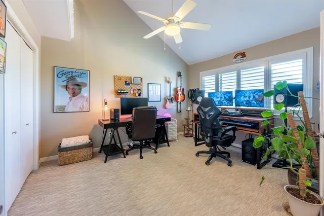 a view of a livingroom with workspace and a window