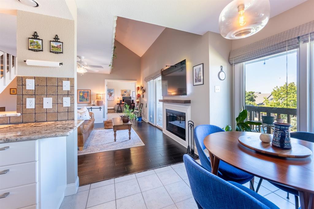 812 Signal Ridge Place Rockwall, TX 75032 - Photo 13 of 29 a living room with fireplace furniture dining table and a large window