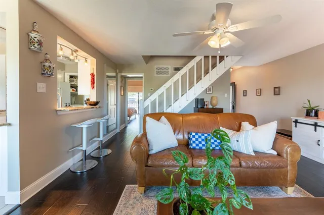 a living room with furniture and a chandelier