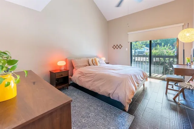 a bedroom with a bed a stove and a large window