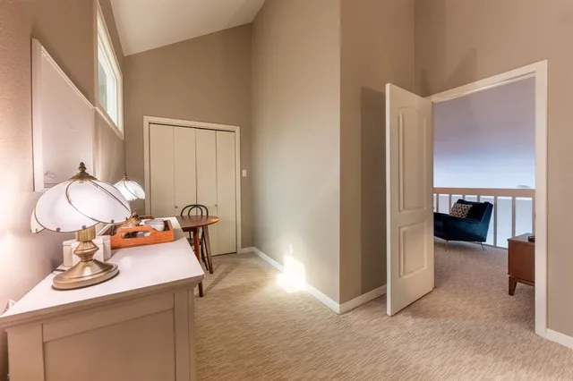 a view of a hallway to a livingroom and a livingroom with furniture