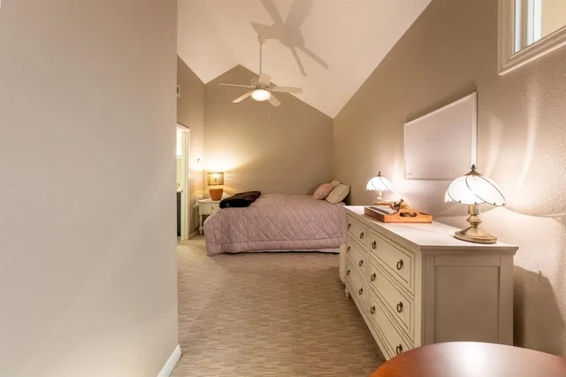 a bedroom with a bed and a lamp with window