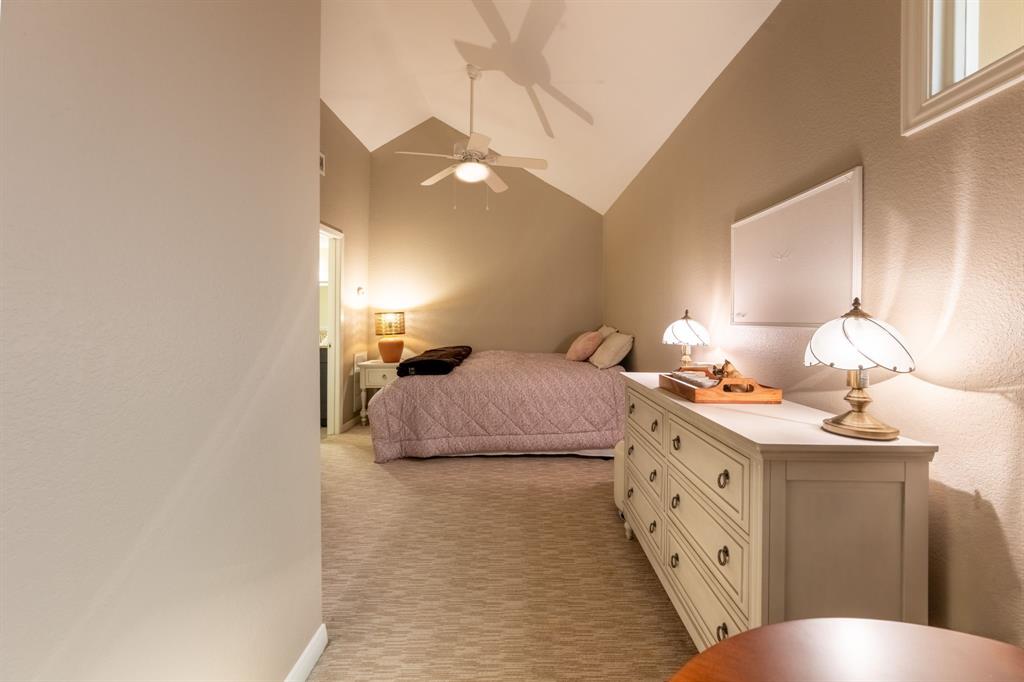 812 Signal Ridge Place Rockwall, TX 75032 - Photo 28 of 29 a bedroom with a bed and a lamp with window