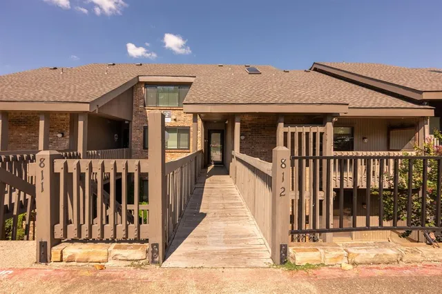 a view of a house with wooden fence