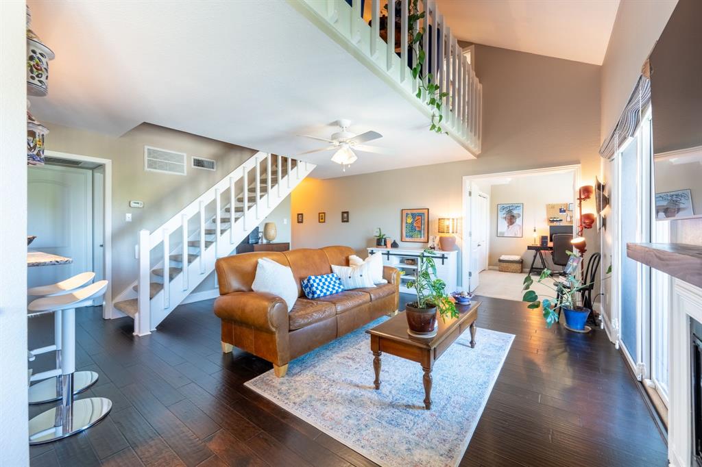 812 Signal Ridge Place Rockwall, TX 75032 - Photo 9 of 29 a living room with furniture and a dining table with wooden floor