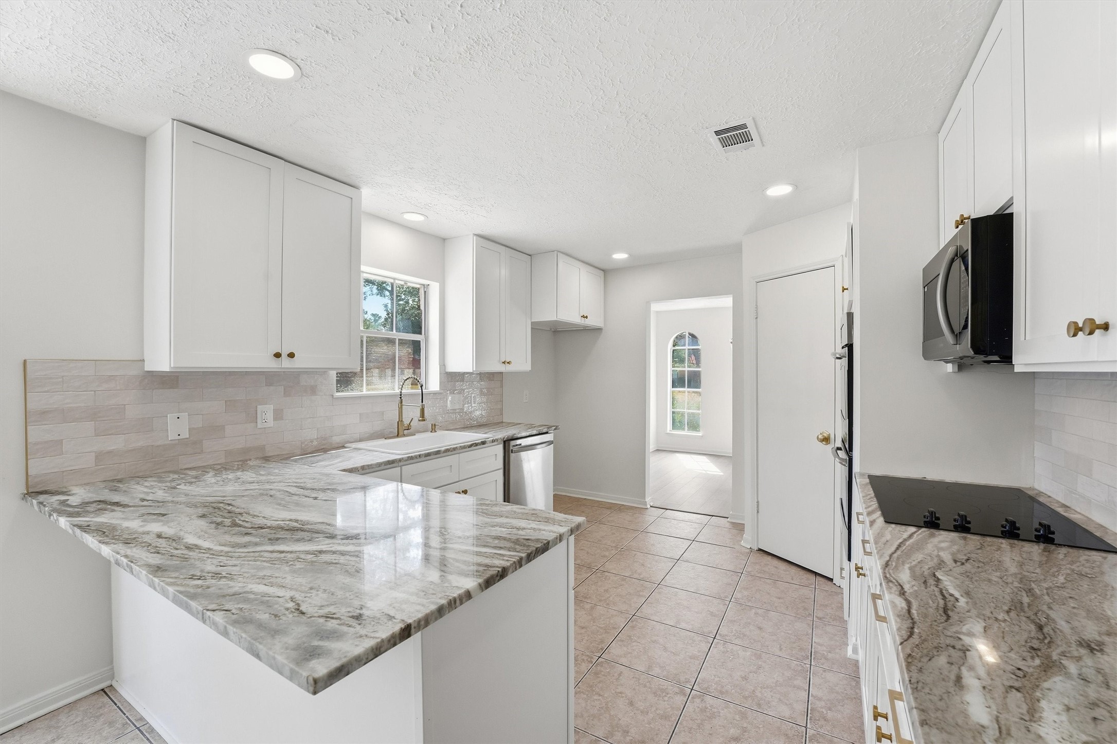 2203 Rolling Meadows Drive Houston, TX 77339 - Photo 13 of 27 a kitchen with stainless steel appliances granite countertop a sink and a refrigerator
