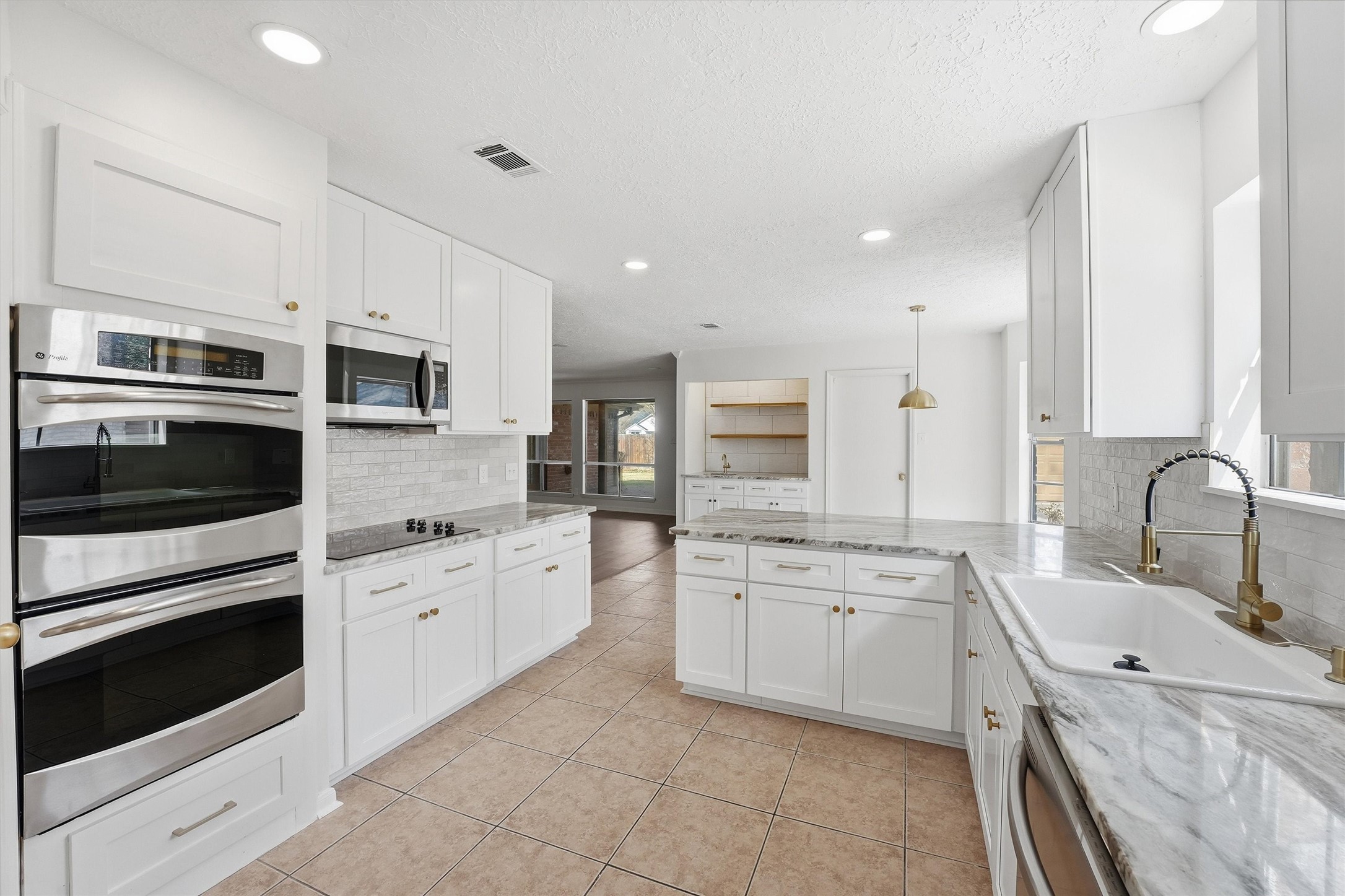 2203 Rolling Meadows Drive Houston, TX 77339 - Photo 14 of 27 a kitchen with granite countertop a sink stainless steel appliances and cabinets