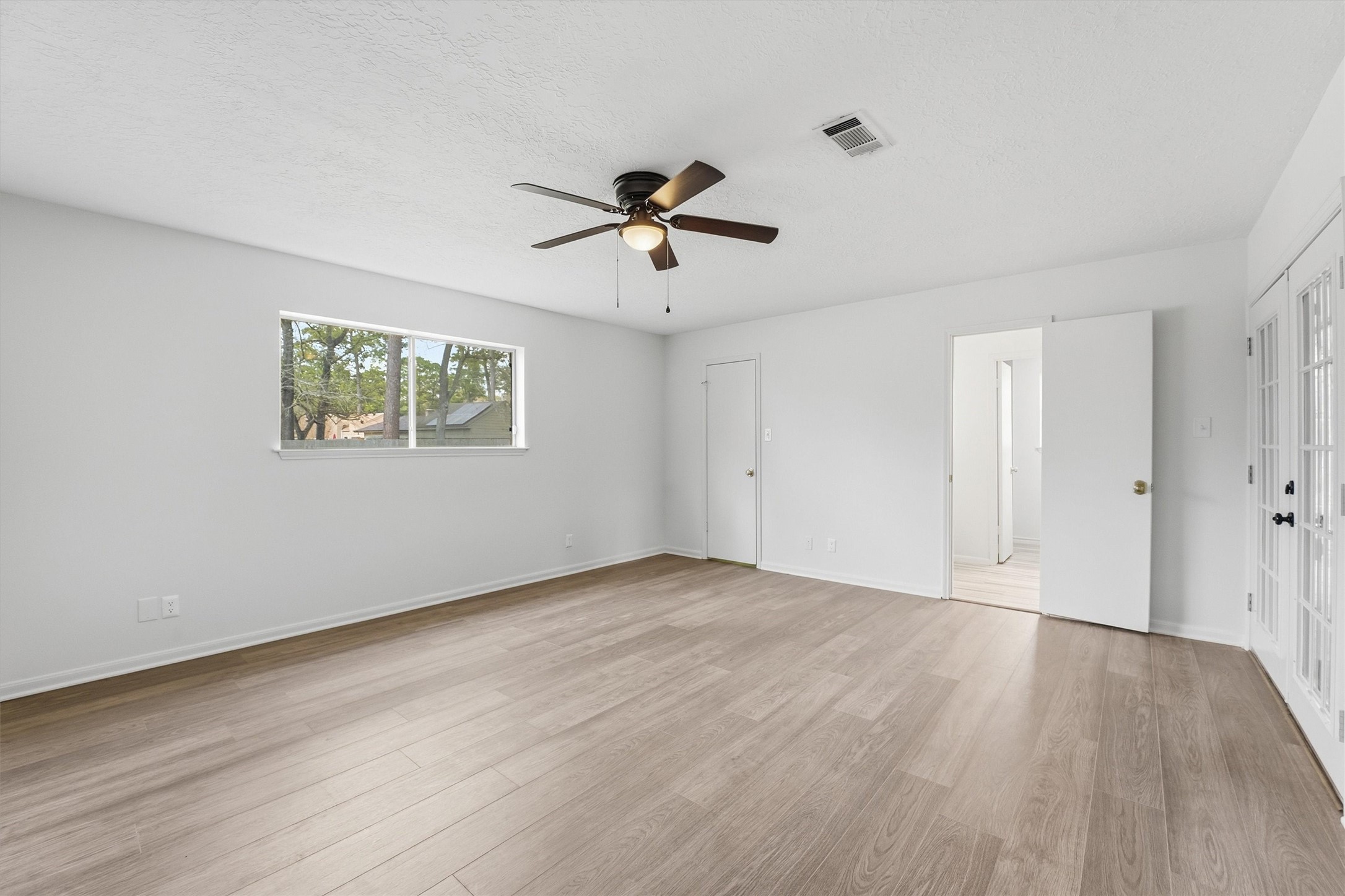 2203 Rolling Meadows Drive Houston, TX 77339 - Photo 21 of 27 a view of a room with wooden floor and a ceiling fan