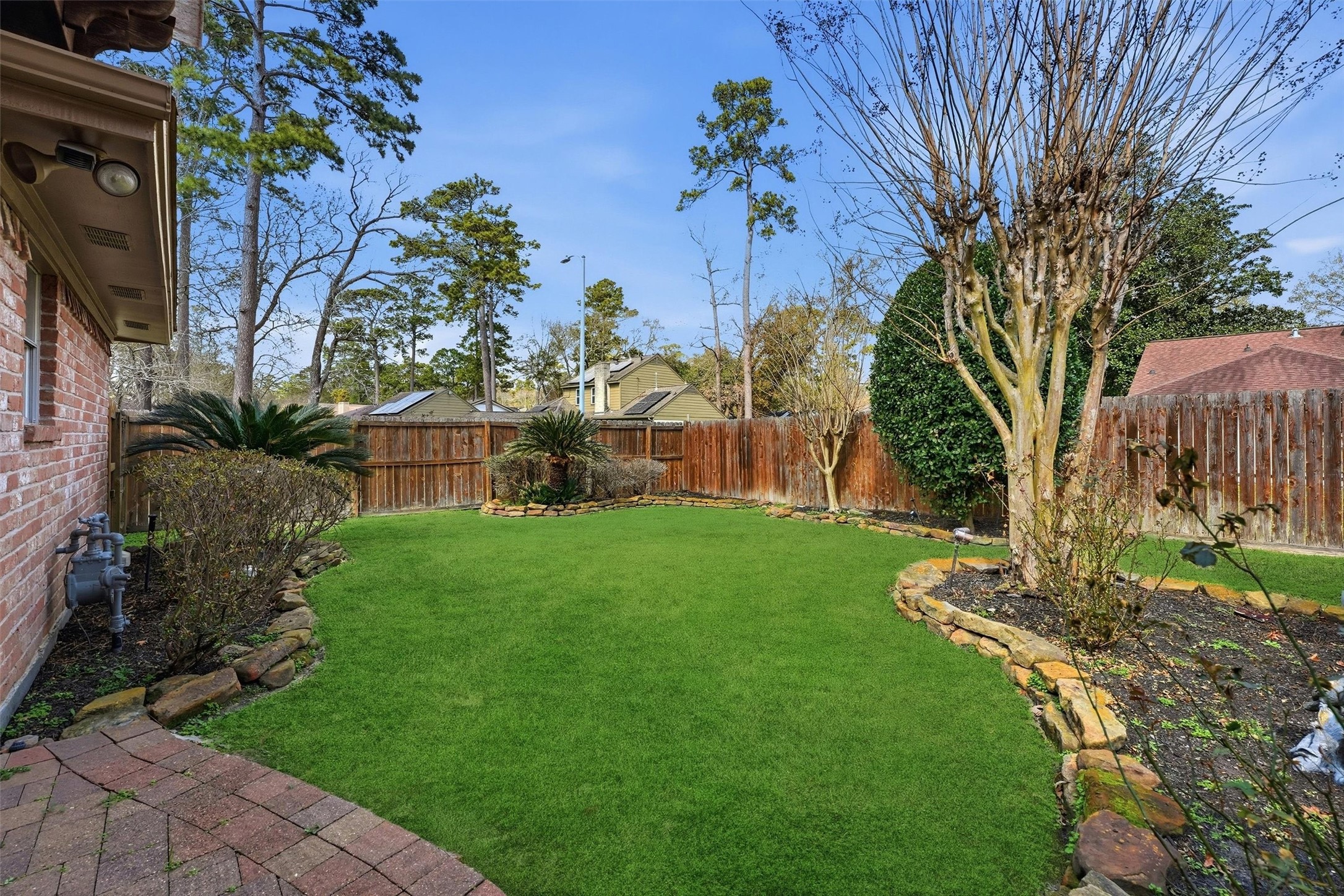 2203 Rolling Meadows Drive Houston, TX 77339 - Photo 26 of 27 a view of a garden with a building in the background