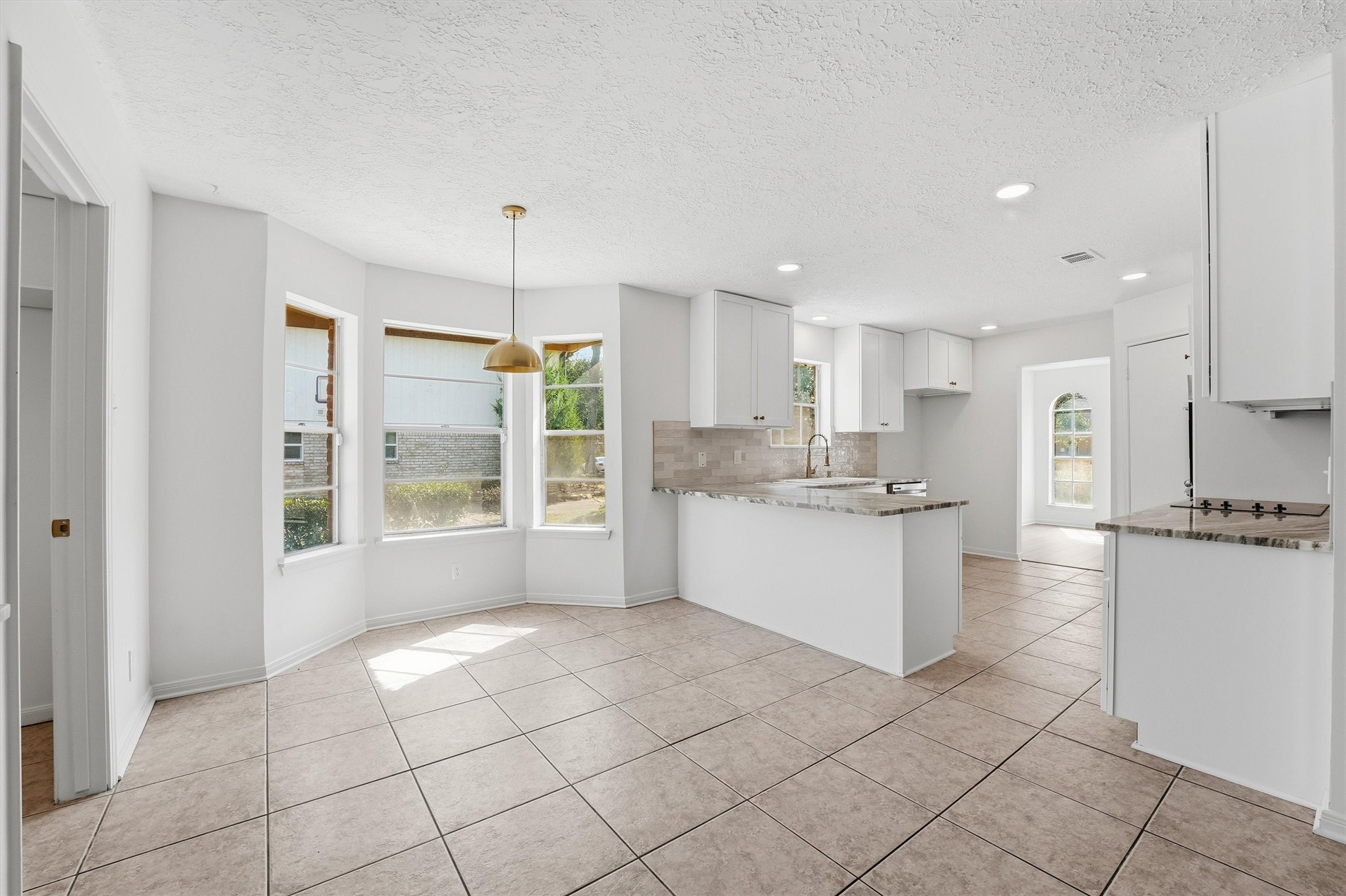 2203 Rolling Meadows Drive Houston, TX 77339 - Photo 4 of 27 a large kitchen with kitchen island white cabinets and white appliances