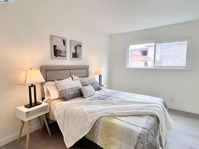 a bedroom with a bed and a night stand