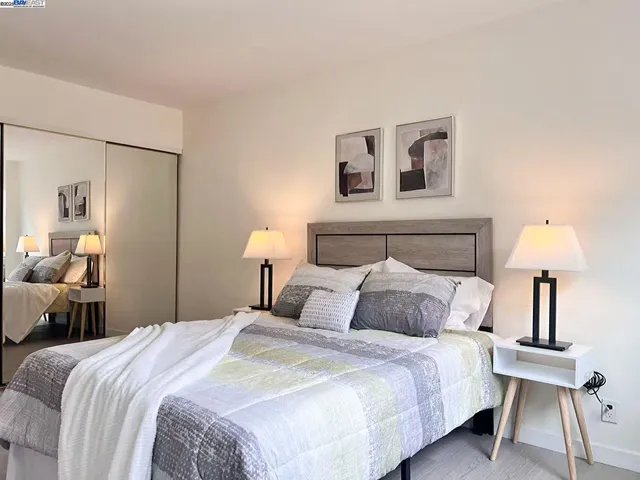 a bedroom with a bed and a lamp