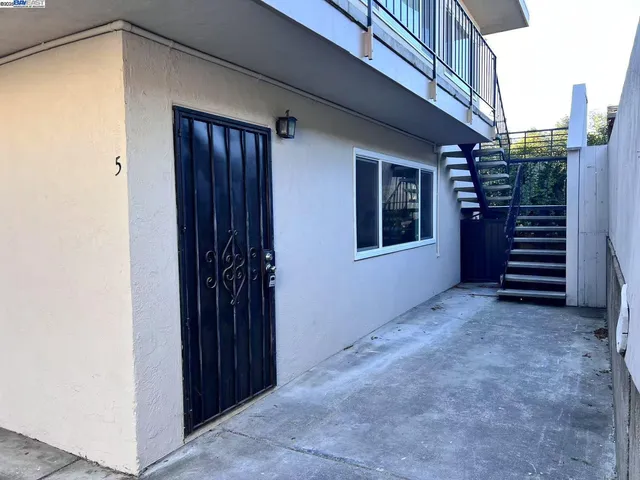 a view of a house with an empty space and porch