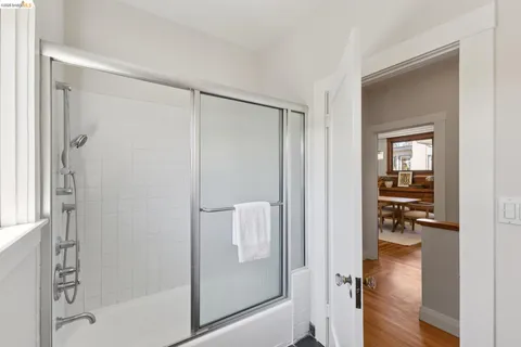 a bedroom with a bed and a large mirror