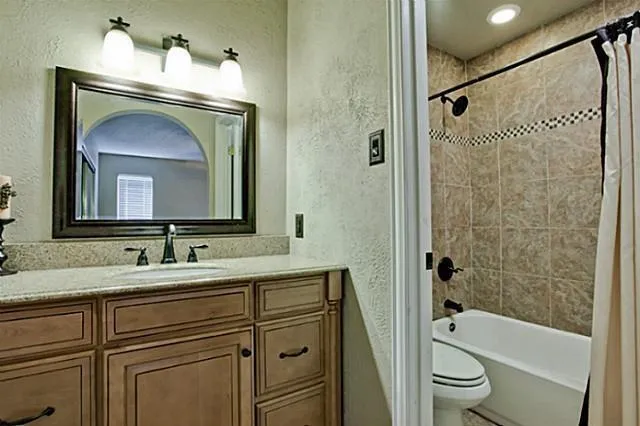 a bathroom with a toilet a sink and bathtub