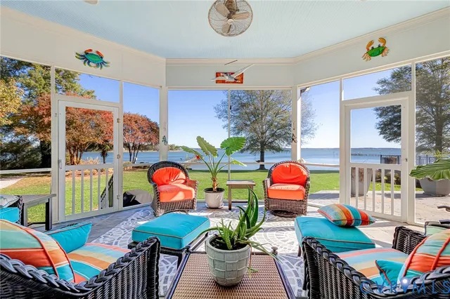 a living room filled with furniture and a floor to ceiling window
