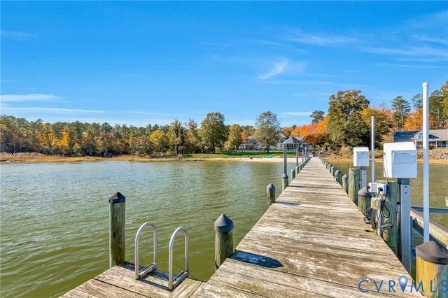 a front view of a house with a garden and tree