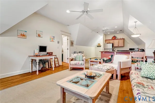 a living room with furniture a fireplace and a large window