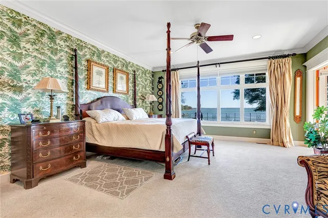 a spacious bedroom with a large bed and a chandelier