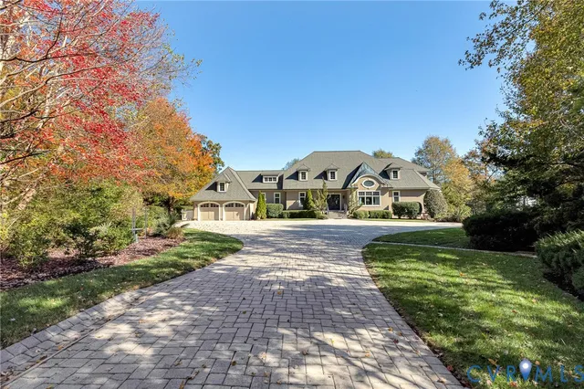 a view of yard with small fountain and large trees