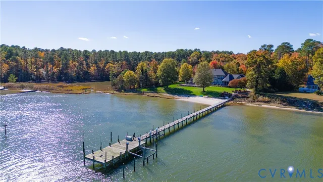a view of a swimming pool with a bench and trees in the background