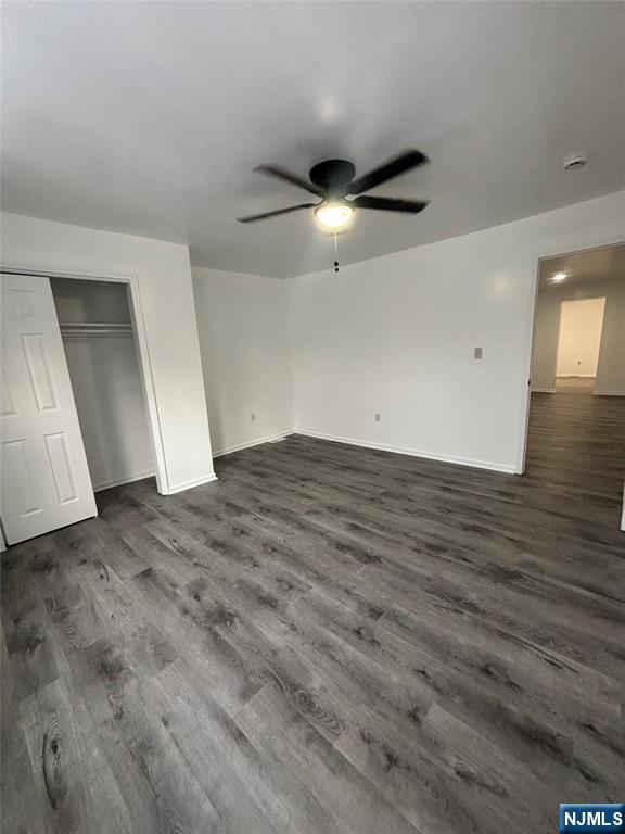 48 1/2 3rd Street Newark, NJ 07107 - Photo 11 of 20 an empty room with wooden floor and way to kitchen