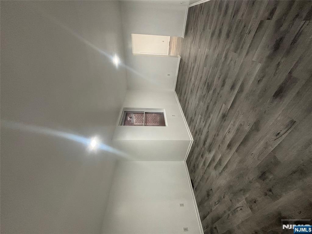 48 1/2 3rd Street Newark, NJ 07107 - Photo 12 of 20 an empty room with wooden floor and windows