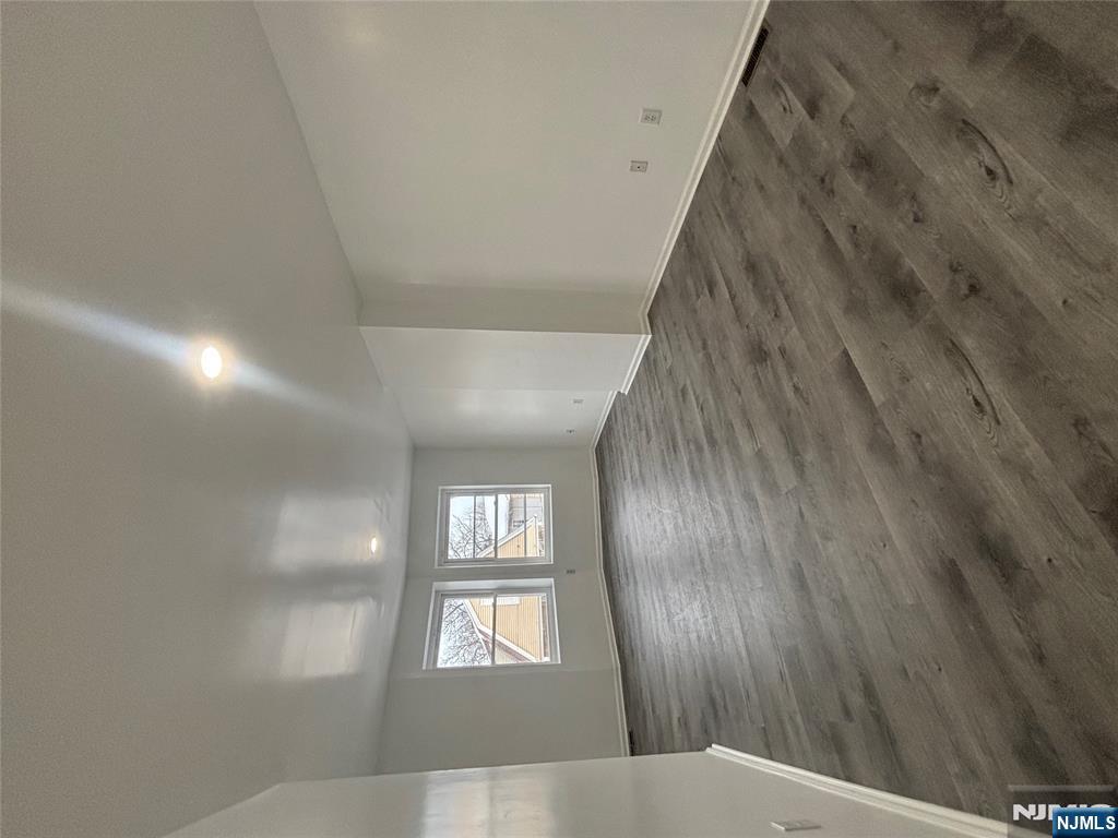 48 1/2 3rd Street Newark, NJ 07107 - Photo 13 of 20 an empty room with wooden floor and windows