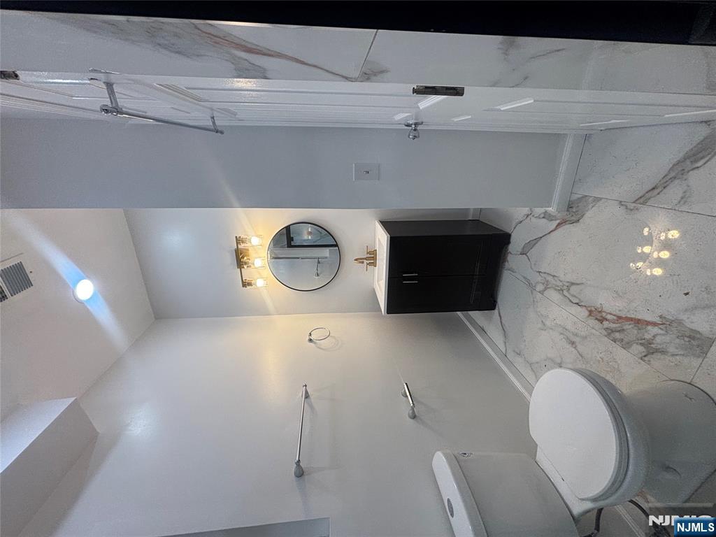 48 1/2 3rd Street Newark, NJ 07107 - Photo 16 of 20 a bathroom with a toilet sink and mirror