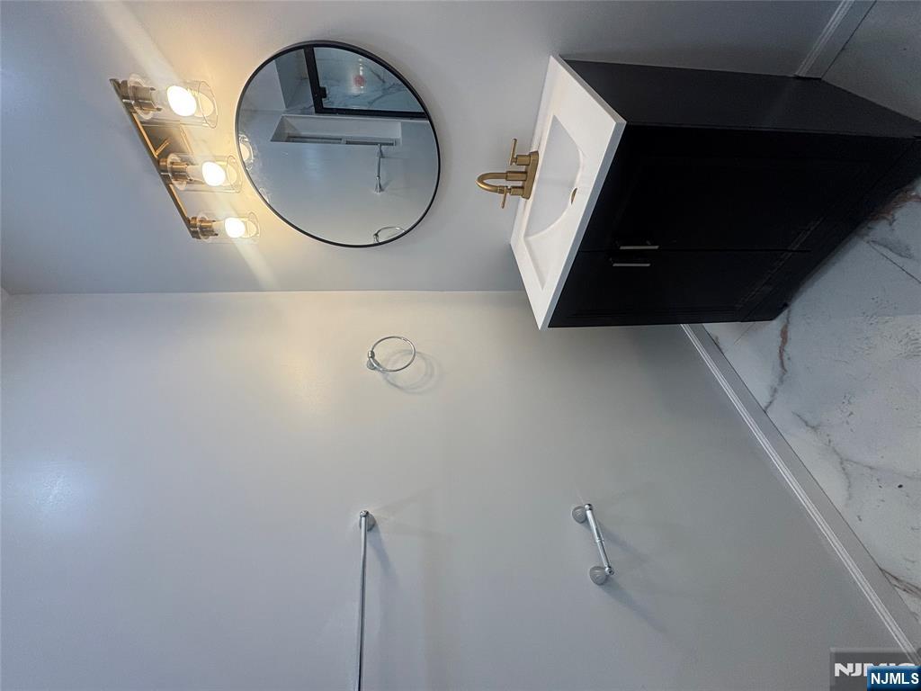 48 1/2 3rd Street Newark, NJ 07107 - Photo 18 of 20 a bathroom with a sink a vanity and a mirror