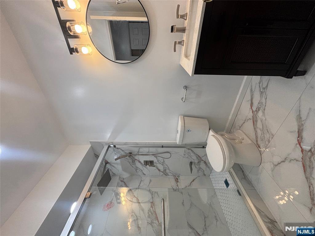 48 1/2 3rd Street Newark, NJ 07107 - Photo 19 of 20 a bathroom with a granite countertop sink toilet and a mirror