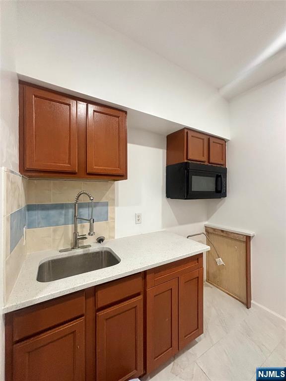 48 1/2 3rd Street Newark, NJ 07107 - Photo 4 of 20 a kitchen with stainless steel appliances granite countertop a sink and a microwave
