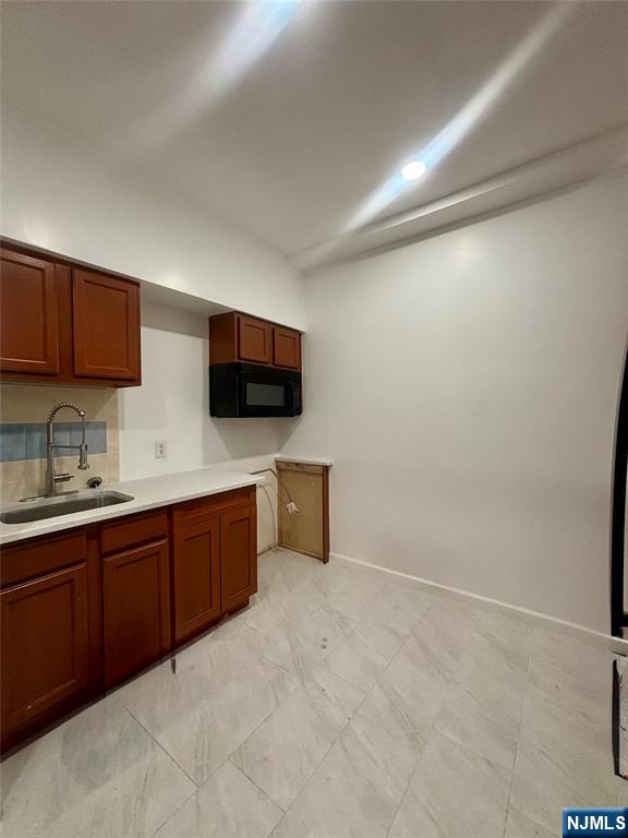 48 1/2 3rd Street Newark, NJ 07107 - Photo 5 of 20 a large kitchen with a sink and a microwave