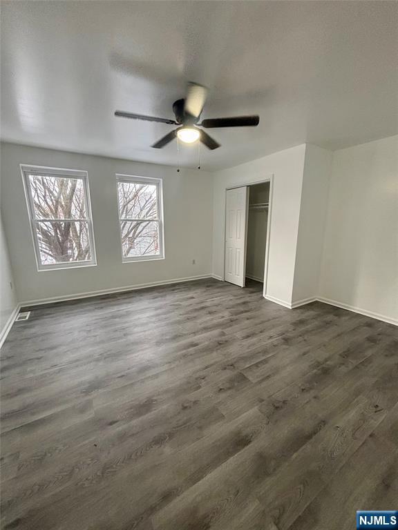 48 1/2 3rd Street Newark, NJ 07107 - Photo 10 of 20 an empty room with wooden floor ceiling fan and windows