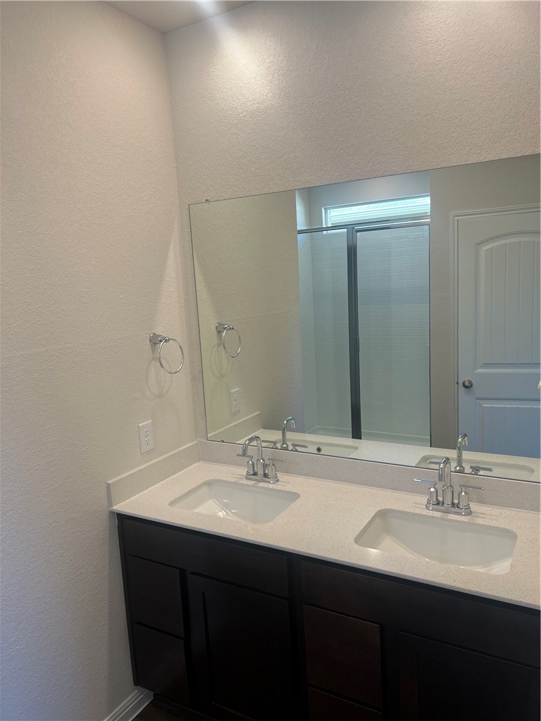 252 Sunniberg Loop Georgetown, TX 78626 - Photo 4 of 17 Dual vanity in primary bathroom with stand up shower.