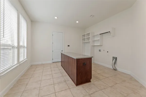a kitchen with stainless steel appliances granite countertop a sink a microwave and wooden cabinets