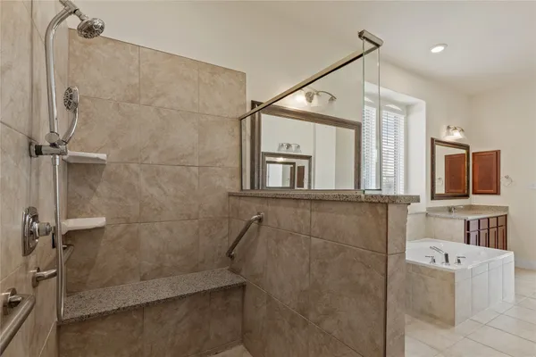 a spacious bathroom with a sink a mirror and bathtub