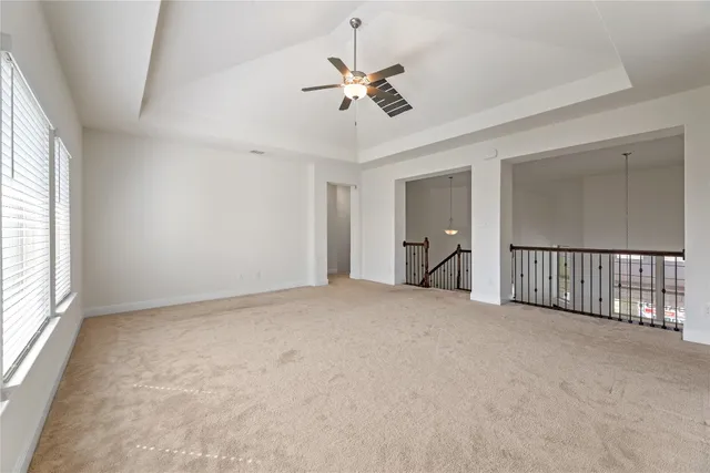 a view of a livingroom with a ceiling fan and window
