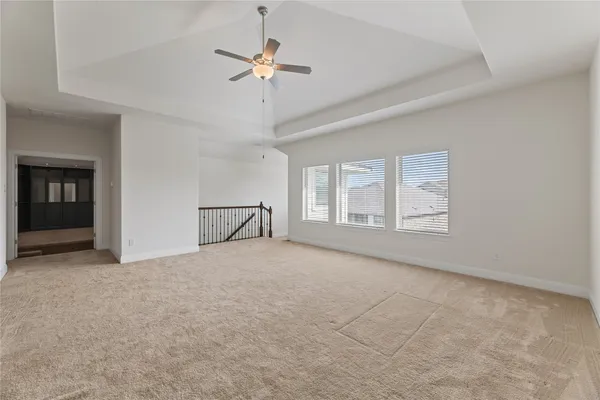 a view of a livingroom with a ceiling fan and window