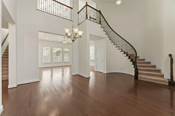 a view of an entryway with wooden floor and stairs