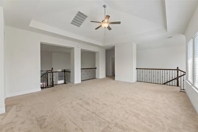 a view of a livingroom with a ceiling fan and window