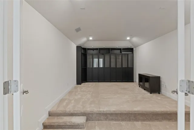 a large white room with wooden floor