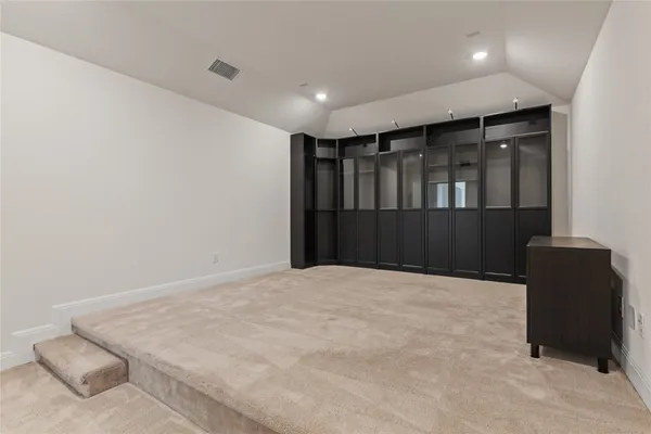 a large white room with wooden floor