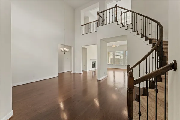 a view of staircase with white walls and wooden floor