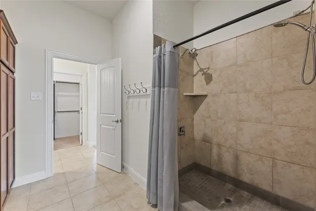a bathroom with a shower and a sink