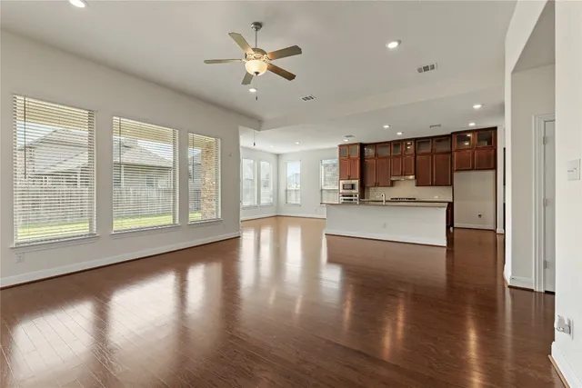 a view of a kitchen with a kitchen island wooden floor and a window
